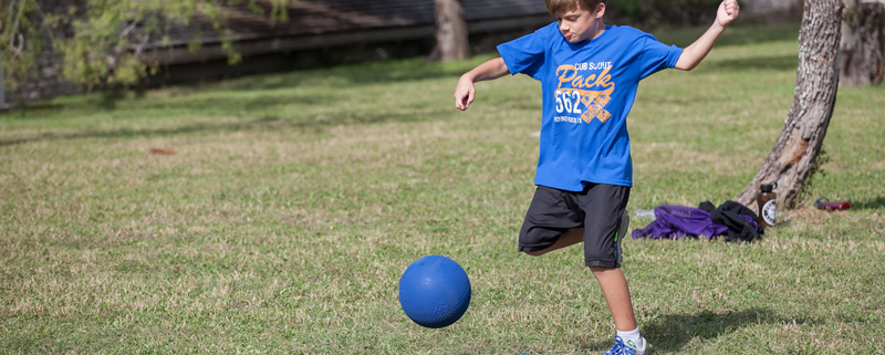 Young Man Playing Kickball