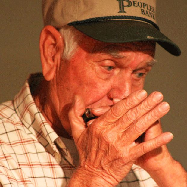 A man performs with a harmonica at Allen Hicks Friday Night Jams inNickelsville