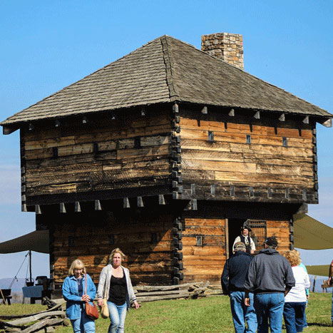 The Blockhouse with visitors walking around it
